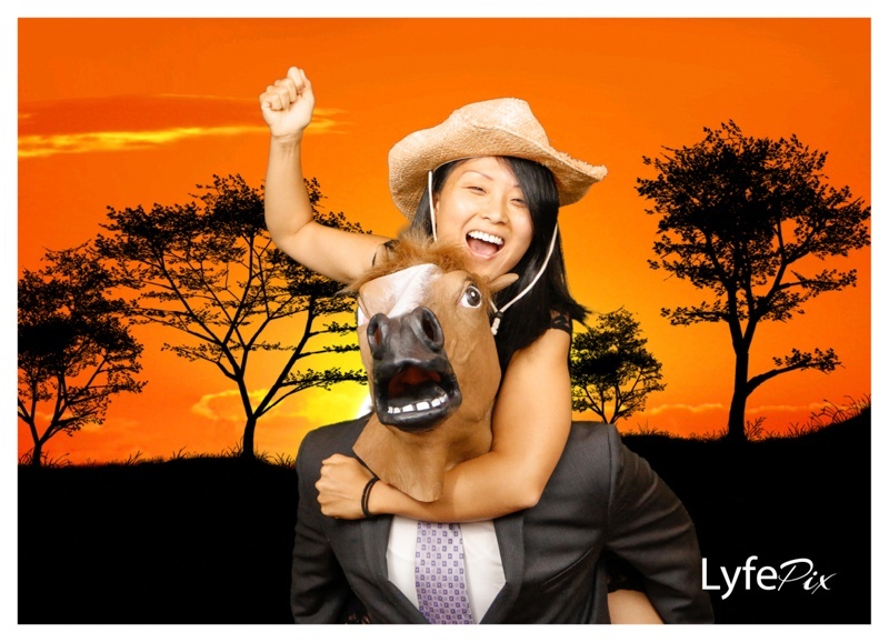 Lynn and Darren's wedding photo booth picture taken in Maryland shows girl with cowboy hat and guy with horse mask
